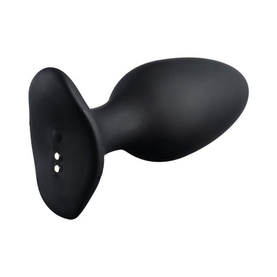Black Lovense Hush 2 app-compatible silicone butt plug with smooth, tapered design and magnetic charging base.
