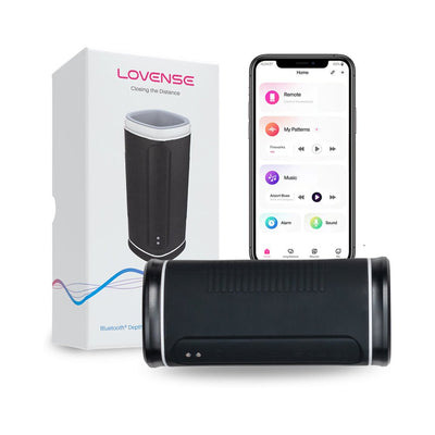 Lovense black app-controlled male masturbator with packaging and smartphone showing control app interface.
