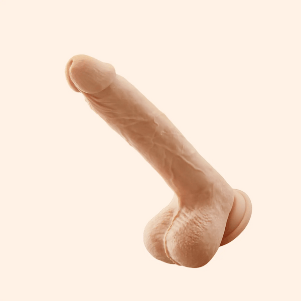 Ivory realistic 8.5-inch thrusting dildo vibrator with suction cup base and lifelike texture.