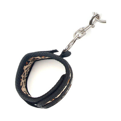 Black and leopard print adjustable wrist cuff with metal swivel clip restraint attachment on white background
