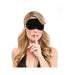 Woman wearing a black blindfold with finger to lips gesture, styled with loose blonde hair and lace top.