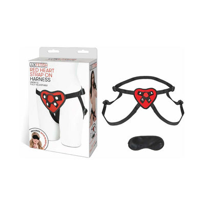 Red heart-shaped adjustable strap on harness with black straps and included black satin blindfold.