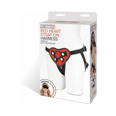 Packaging of Lux Fetish Red Heart Strap On Harness featuring adjustable black straps and a red heart-shaped front panel.