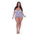 Plus size model wearing periwinkle lace babydoll with split crotch panty and adjustable straps, paired with white heels.