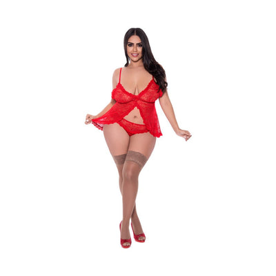 Woman wearing a red lace babydoll with split crotch panty, sheer thigh-high stockings, and red heels on white background.