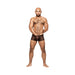 Male model wearing black sheer mesh Heart Breaker mini shorts with a miniature heart pattern, standing against white background.
