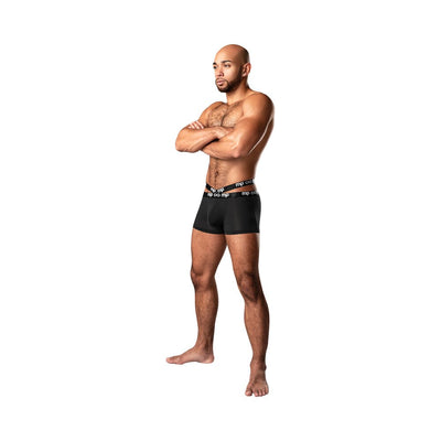 Athletic man wearing black Male Power Infinite Comfort amplifying strappy pouch shorts with dual logo waistbands, standing with arms crossed.