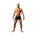 Athletic man wearing black Male Power Infinite Comfort amplifying strappy pouch shorts with dual elastic waistbands.