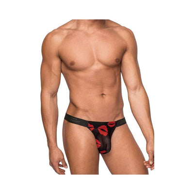 Male model wearing Male Power Kiss Me Micro Thong with black sheer fabric and red lips print.