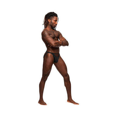 Athletic man wearing black Male Power Magnificence jock with metal grommet details and plush elastic waistband, standing in profile.