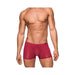 Male model wearing seamless wine-colored sleek mini shorts with sheer pouch and low-rise waist.