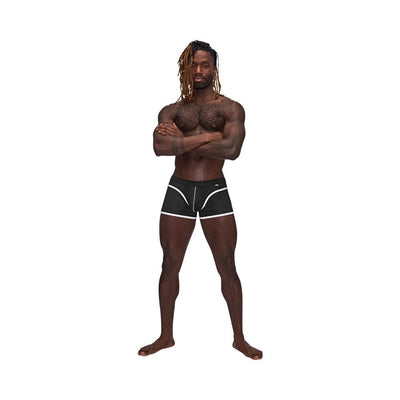 Athletic male model wearing black Male Power Sport Mesh Mini Shorts with white trim standing with arms crossed.