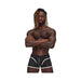 Athletic man wearing black Male Power Sport Mesh mini shorts with white trim and logo on waistband against white background.