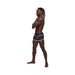 Male model wearing black Male Power Sport Mesh mini shorts with white trim standing in profile on white background