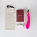 Pink curved G-spot vibrator with rose gold touch panel, USB charging cable, instruction booklet, and beige storage pouch.