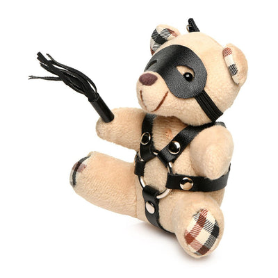 Plush teddy bear keychain with faux leather bondage harness, black eye mask, and mini flogger accessory.