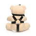 Plush light peach teddy bear keychain wearing black faux leather harness with metal ring, shown from the back on white background.