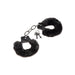 Black furry handcuffs with soft faux fur lining and metal chain, including two small keys on a white background.