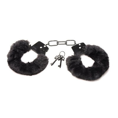 Black furry handcuffs with soft faux fur lining and metal chain, including two small silver keys on a white background.