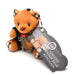 Plush brown teddy bear keychain with plaid accents, wearing black faux leather cuffs and a red ball gag, attached to a product tag.