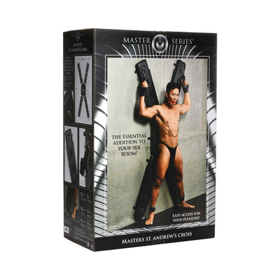 Packaging box for Masters St. Andrew's Cross featuring a model demonstrating the wall-mounted padded cross with wrist and ankle restraints.