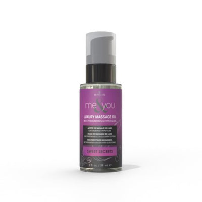 Bottle of Me and You Luxury Massage Oil in Sweet Secrets scent with a purple label and pump dispenser.