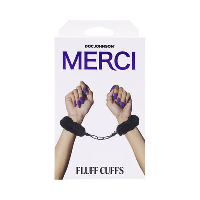 Merci Fluff Cuffs black metal handcuffs with plush faux fur lining shown on wrists with purple nails on white packaging.