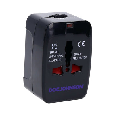 Black Doc Johnson travel universal adapter and surge protector with multiple plug slots and a locking switch.