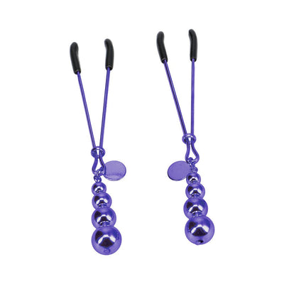 Pair of purple metal nipple clamps with graduated bead charms and black silicone tips on white background