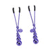Pair of purple metal nipple clamps with graduated bead charms and black silicone tips on white background