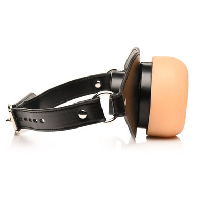 Adjustable black vegan leather strap gag with a realistic beige TPE textured front piece.