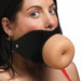 Close-up of a woman wearing a black vegan leather mouth gag with a realistic, flesh-toned TPE front piece.