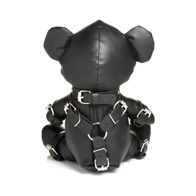 Back view of black vegan leather teddy bear dressed in detailed gimp harness with silver buckles and straps.
