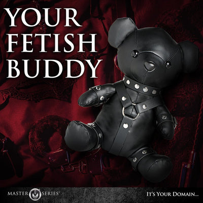 Black vegan leather teddy bear dressed in detailed gimp harness and cuffs, styled as a kinky novelty companion.