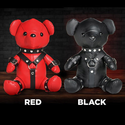 Two vegan leather teddy bears in red and black, each dressed in detailed gimp harness outfits with metal studs and buckles.