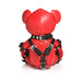 Red vegan leather teddy bear dressed in black gimp harness with silver buckles, shown from the back on white background.