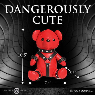 Red vegan leather teddy bear wearing black gimp harness straps with metal studs, measuring 10.5 by 7.4 by 5.3 inches.