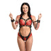 Woman wearing a black vegan leather adjustable harness with gold accents and matching wrist restraints over red lace lingerie.