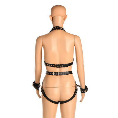 Back view of a mannequin wearing a black vegan leather adjustable harness with gold metal accents and attached wrist cuffs.