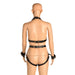 Back view of a mannequin wearing a black vegan leather adjustable harness with gold metal accents and attached wrist cuffs.
