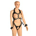 Black vegan leather adjustable full body harness with gold metal accents and attached wrist cuffs on mannequin.