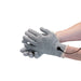 Hands wearing gray Mystim Magic electro-conductive gloves connected by a wire for electro stimulation play.