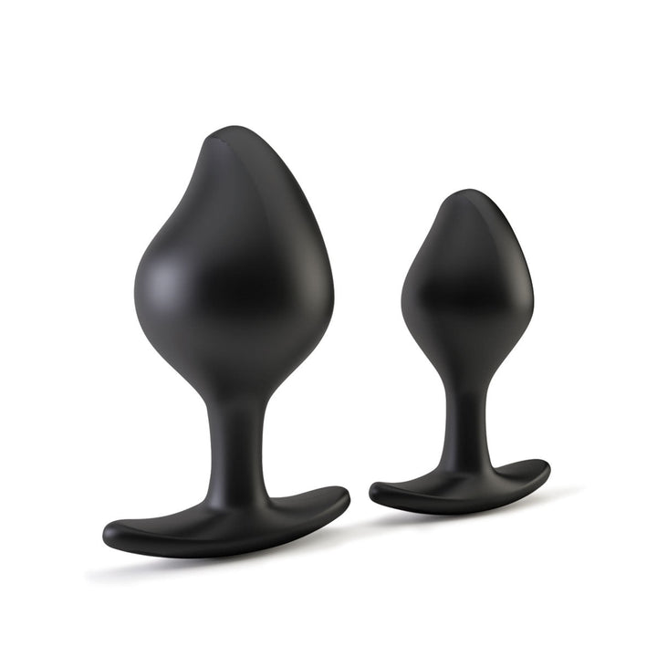 Two black silicone tapered anal plugs with flared bases, shown in large and small sizes on a white background.