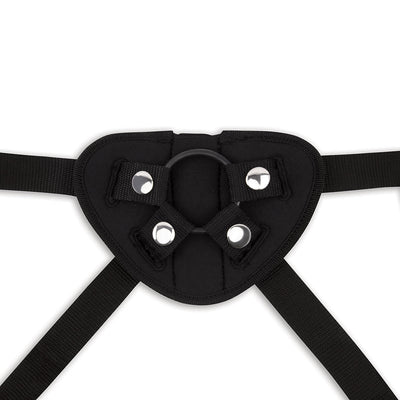 Close-up of black adjustable strap-on harness with metal snaps and O-ring attachment point.