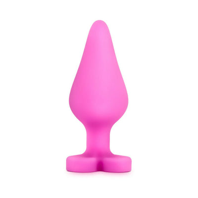 Pink silicone anal plug with heart-shaped base, smooth satin finish, and tapered design for comfortable use.