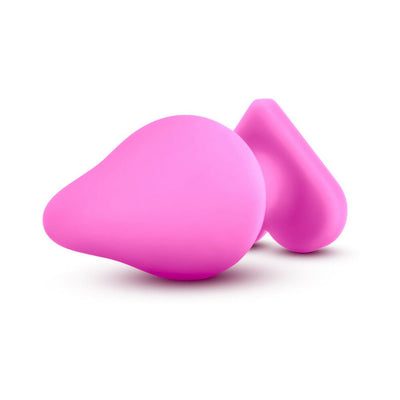 Pink silicone anal plug with a heart-shaped base, smooth satin finish, and tapered tip for comfortable use.