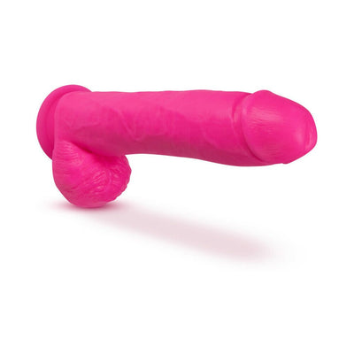 Bright pink 11-inch realistic silicone dildo with dual-density texture and attached balls on a white background.