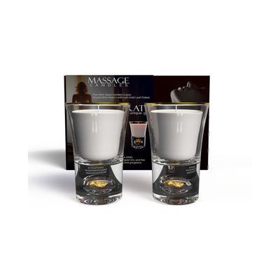 Set of two white massage candles in clear shot glass holders with 24K gold leaf accents and gold rims, displayed with packaging.