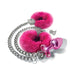 Medium-sized pink metal butt plug with matching pink furry handcuffs and silver chain with keys on white background.