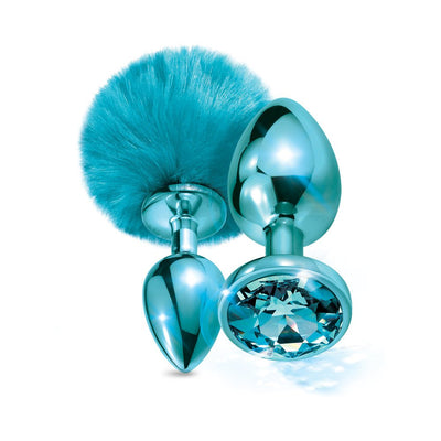 Metallic blue butt plug set with a fluffy pom pom tail and a jewel-inlaid base, polished smooth finish.